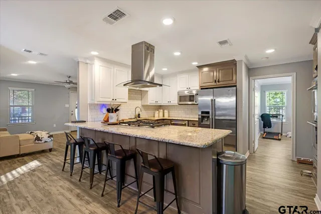 a large kitchen with a table and chairs