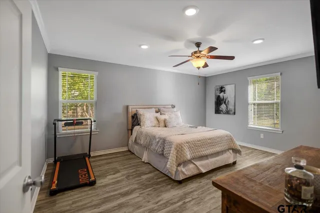 a bedroom with a bed and a chandelier