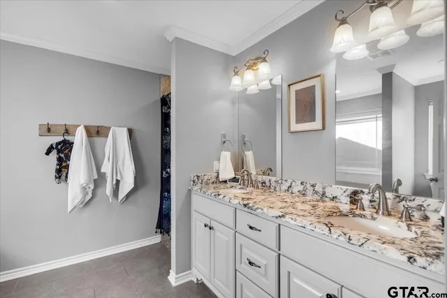 a bathroom with a double vanity sink and a mirror