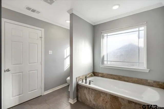 a bathroom with a tub shower and sink
