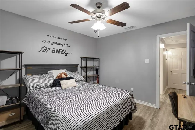 a bedroom with a bed and a chandelier