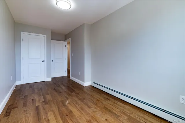 a view of room with wooden floor