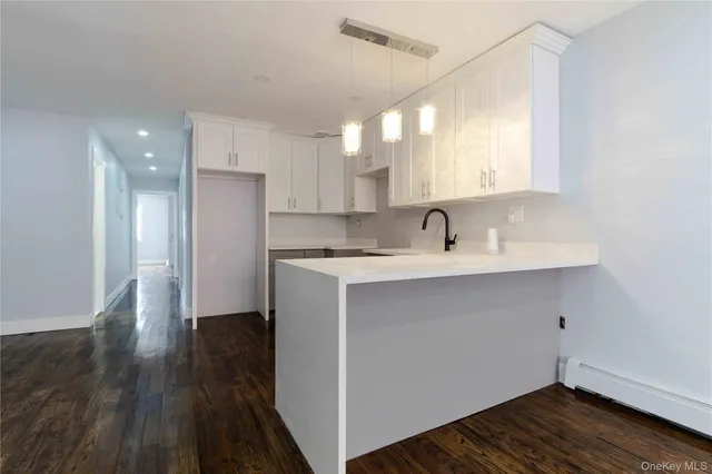 a view of a sink and a refrigerator in a room