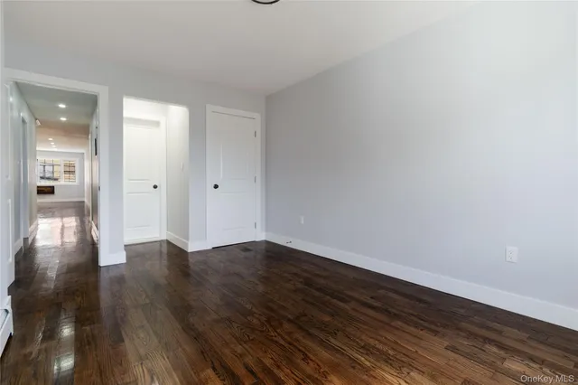 a view of an empty room and wooden floor