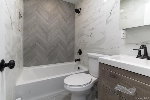 a bathroom with a sink a toilet and bathtub