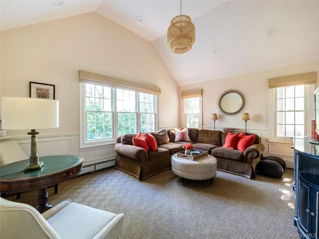 a living room with furniture a fireplace and a large window