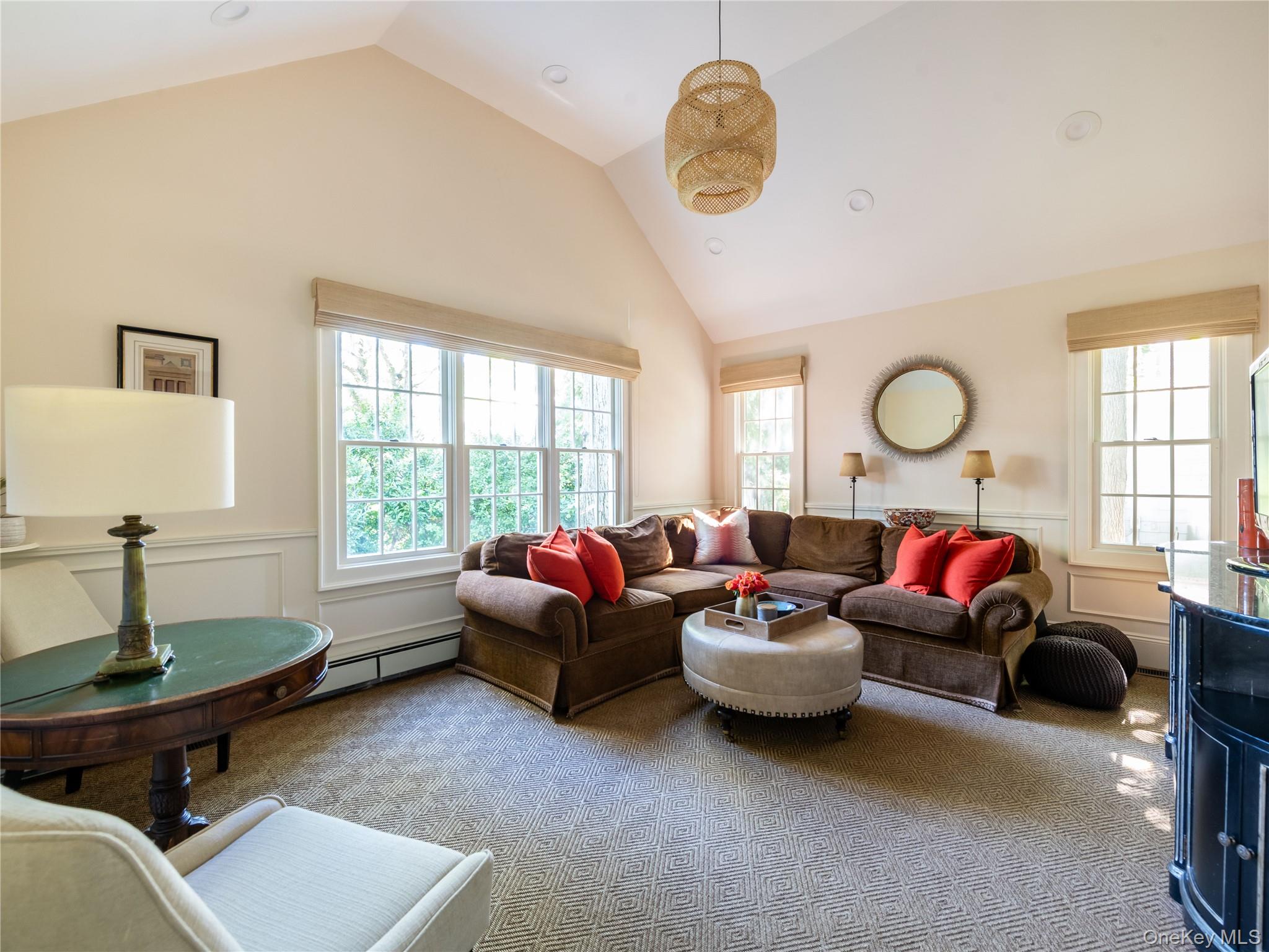 50 Eakins Road Manhasset, NY 11030 - Photo 12 of 24 a living room with furniture a fireplace and a large window