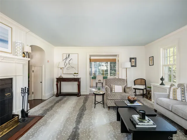 a living room with furniture a fireplace and wooden floor