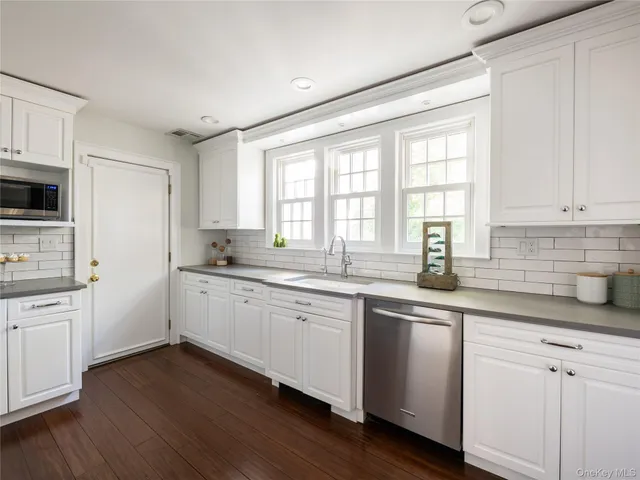 a kitchen with sink cabinets and wooden floor
