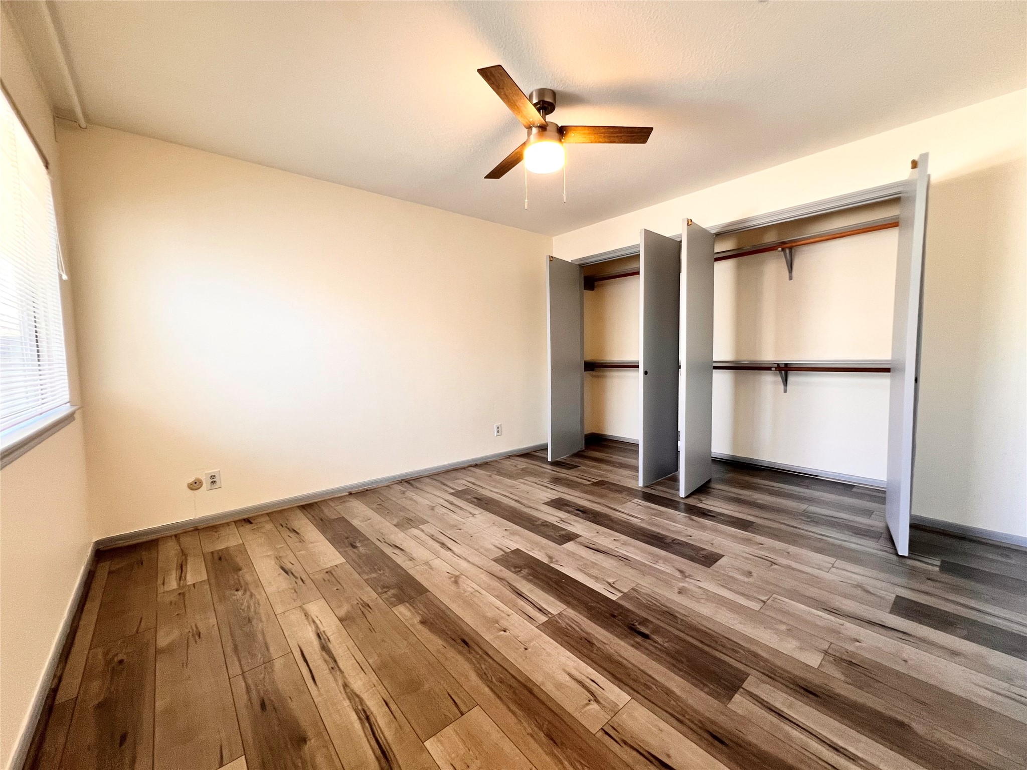 727 Bunker Hill Road, Unit 92 Houston, TX 77024 - Photo 27 of 36 a view of a room with wooden floor and white walls