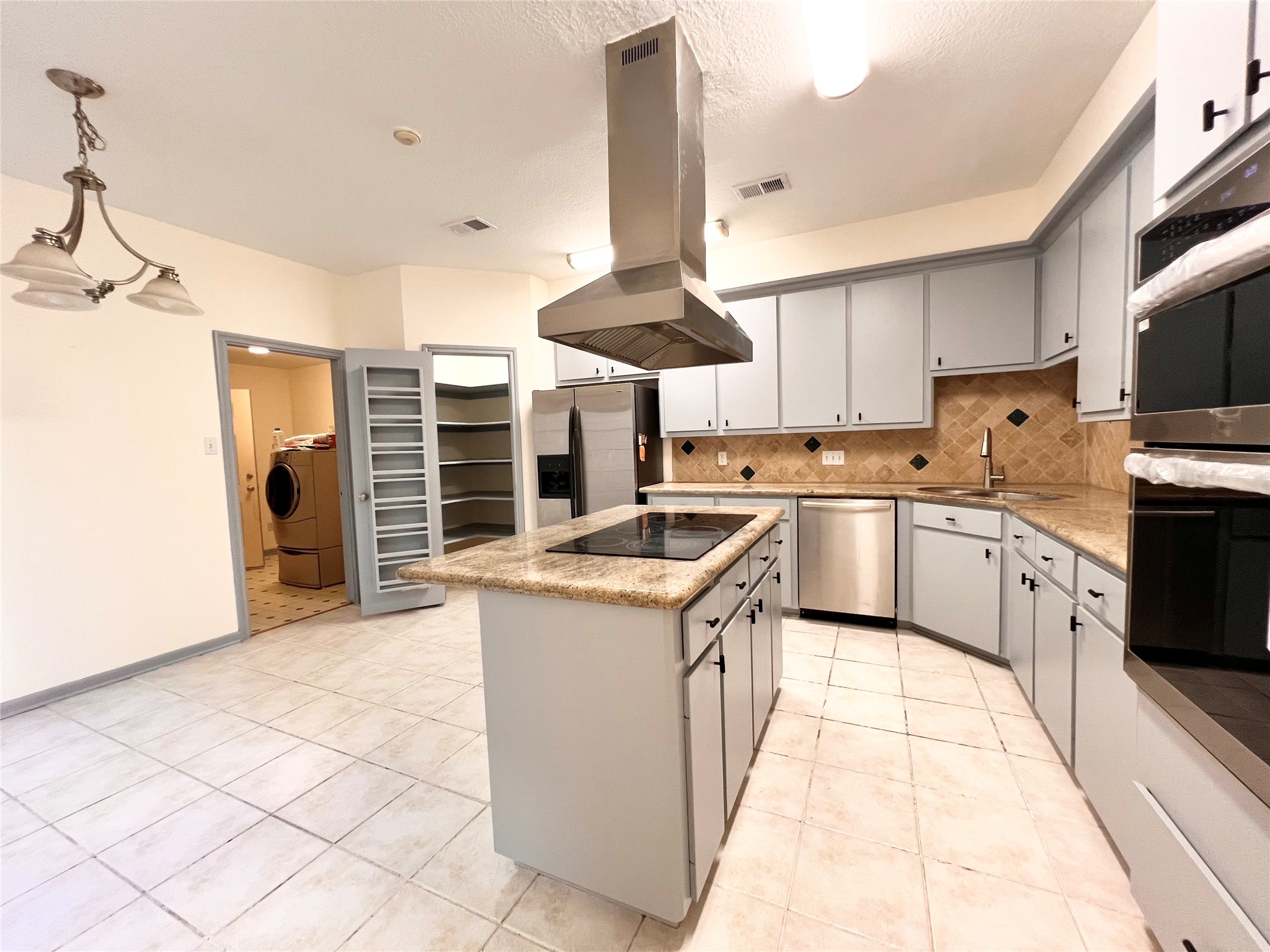 727 Bunker Hill Road, Unit 92 Houston, TX 77024 - Photo 9 of 36 a kitchen with a stove sink and cabinets