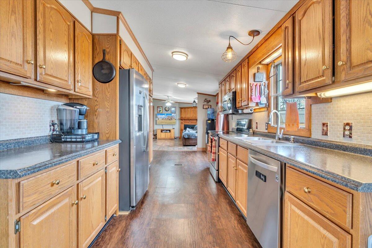 627-641 Novelty Road Penhook, VA 24137 - Photo 15 of 64 a kitchen with stainless steel appliances granite countertop a lot of counter space and wooden floor
