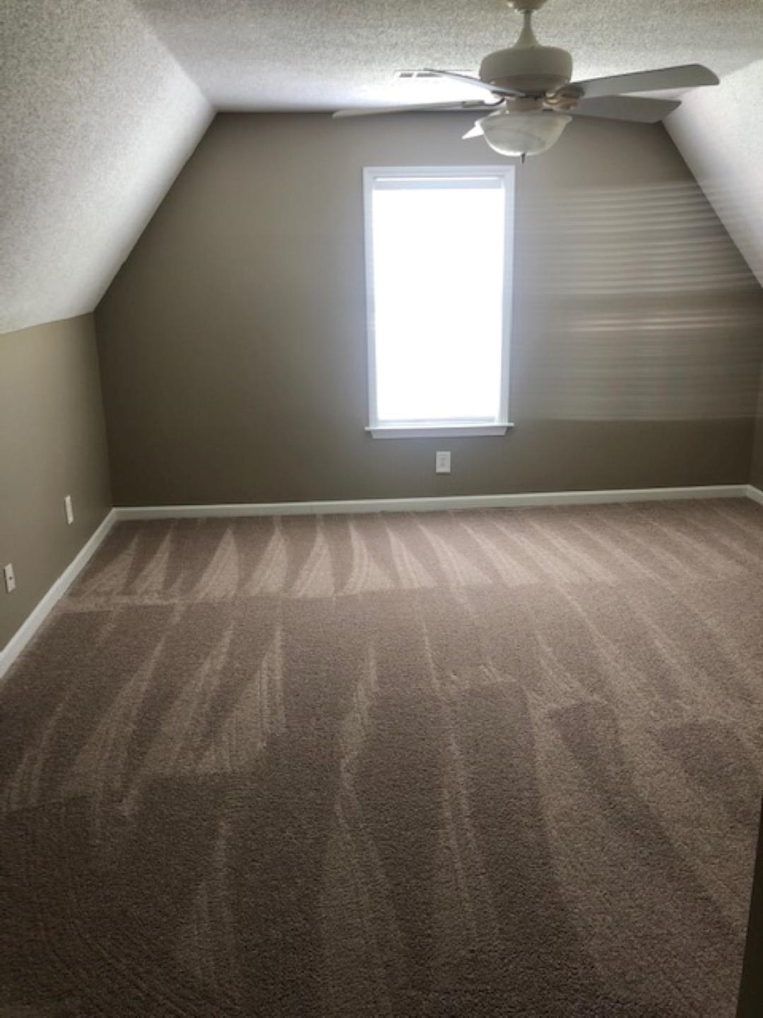 1386 Milestone Circle Collierville, TN 38017 - Photo 11 of 16 Additional living space with a textured ceiling, vaulted ceiling, carpet, and a ceiling fan