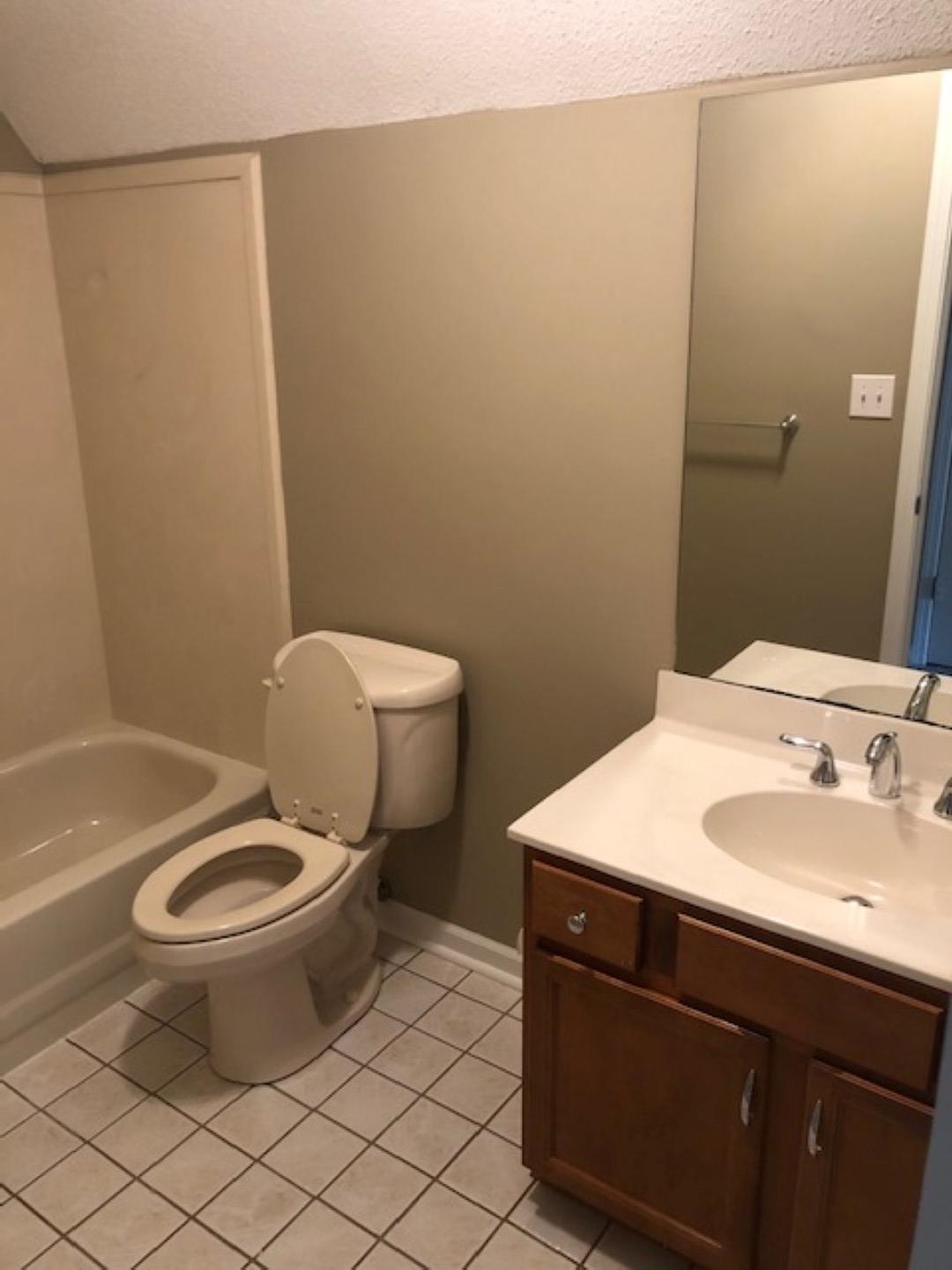 1386 Milestone Circle Collierville, TN 38017 - Photo 12 of 16 Bathroom with a textured ceiling, light tile patterned floors, vanity, and bathtub / shower combination