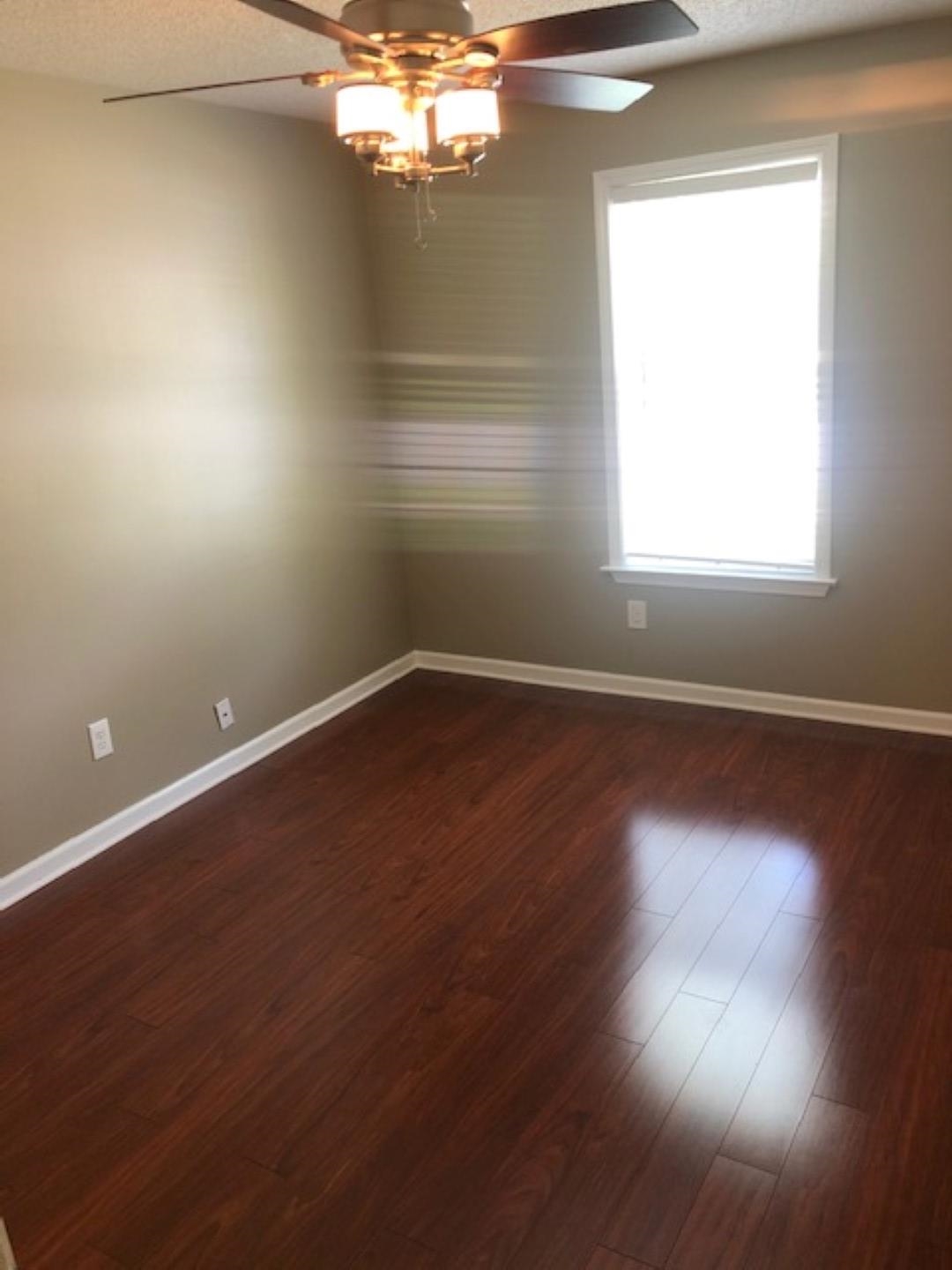 1386 Milestone Circle Collierville, TN 38017 - Photo 4 of 16 Spare room featuring a textured ceiling, dark wood-style floors, and ceiling fan