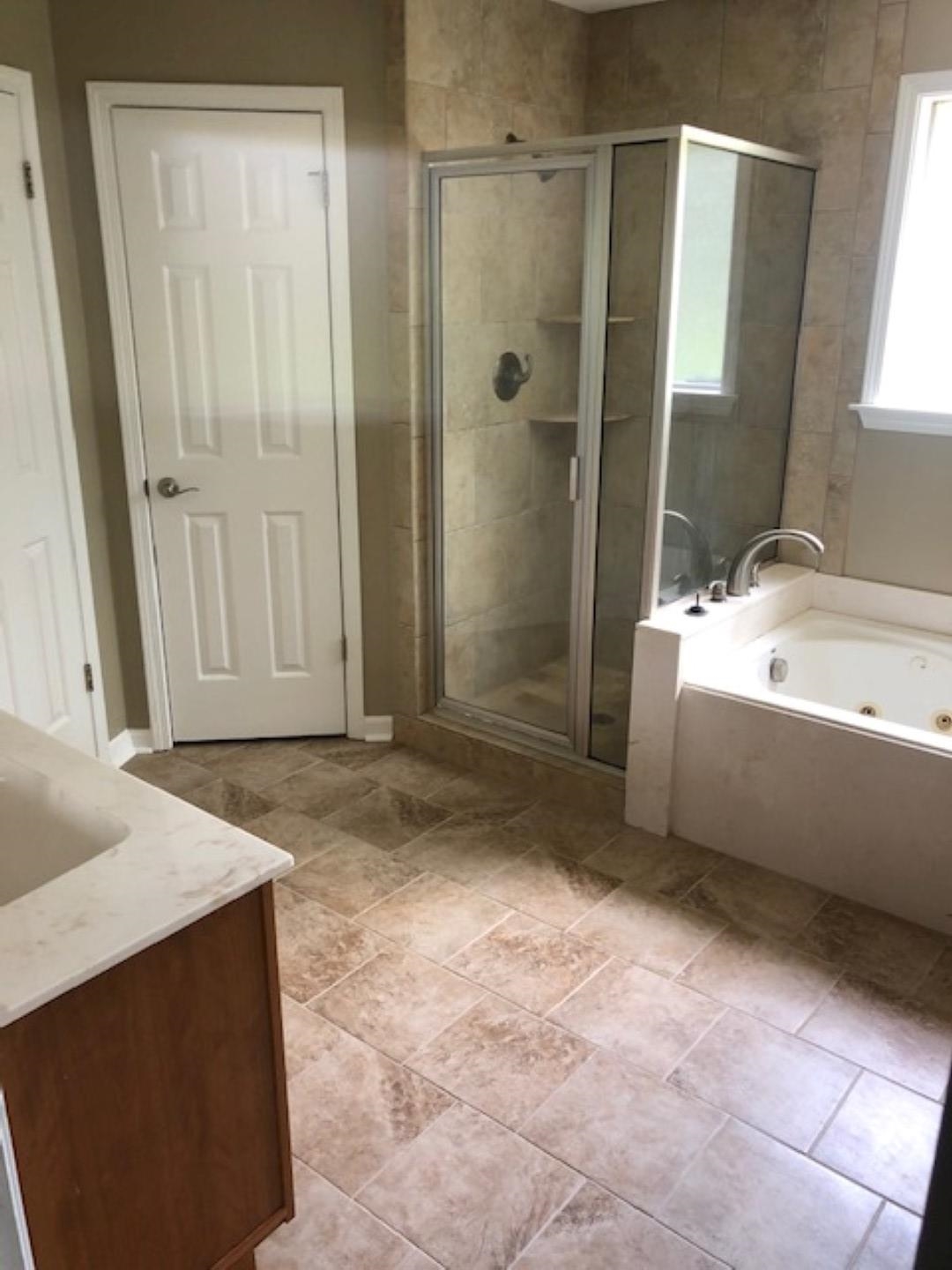 1386 Milestone Circle Collierville, TN 38017 - Photo 8 of 16 Full bathroom featuring vanity, a tub with jets, and a stall shower