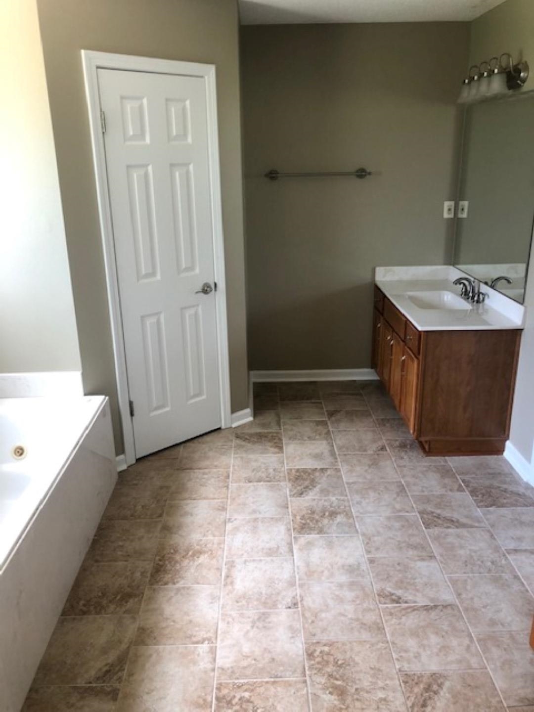 1386 Milestone Circle Collierville, TN 38017 - Photo 9 of 16 Full bathroom with vanity and a tub with jets