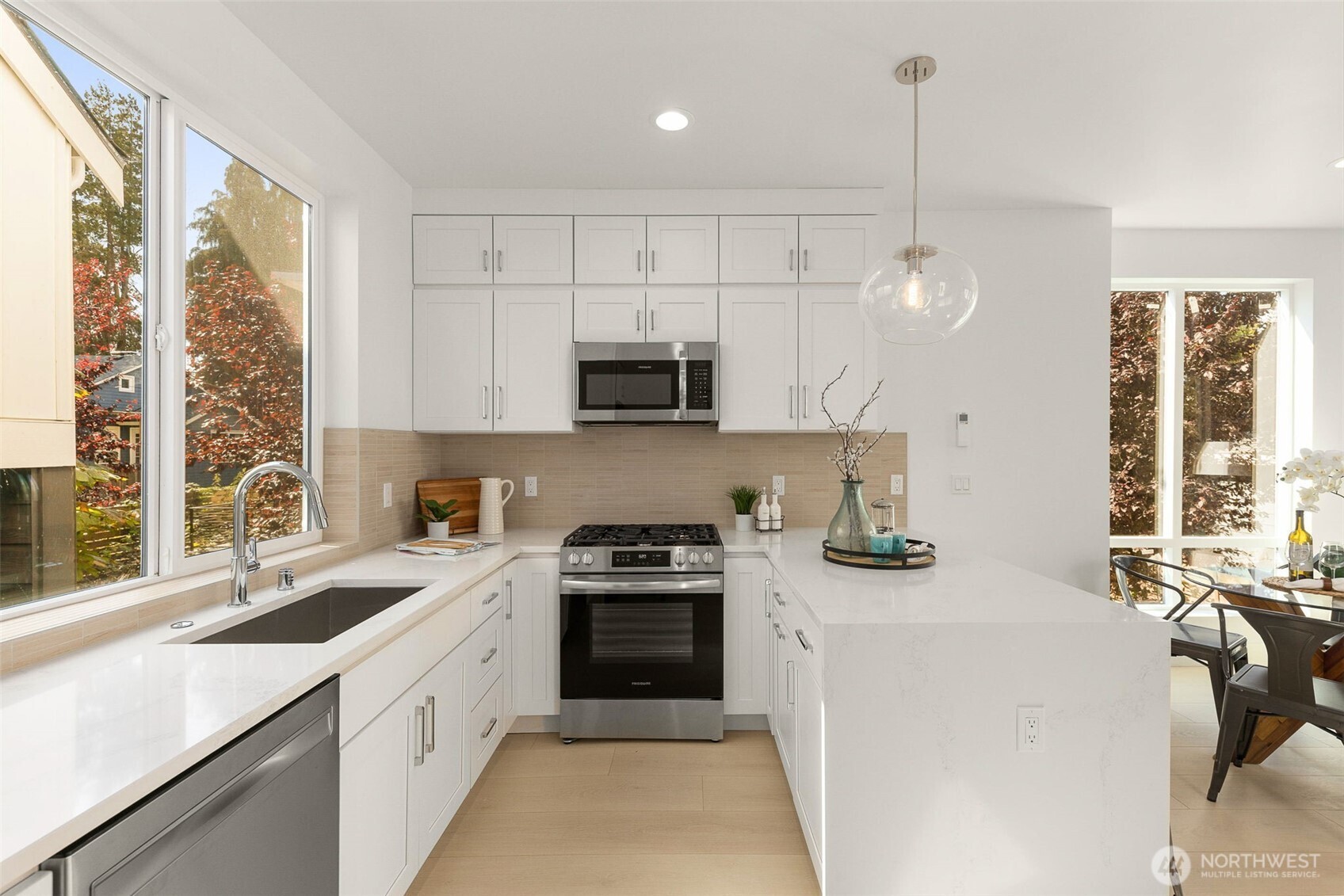 911 North 98th Street, Unit A Seattle, WA 98103 - Photo 12 of 26 a kitchen with a sink a stove and a microwave