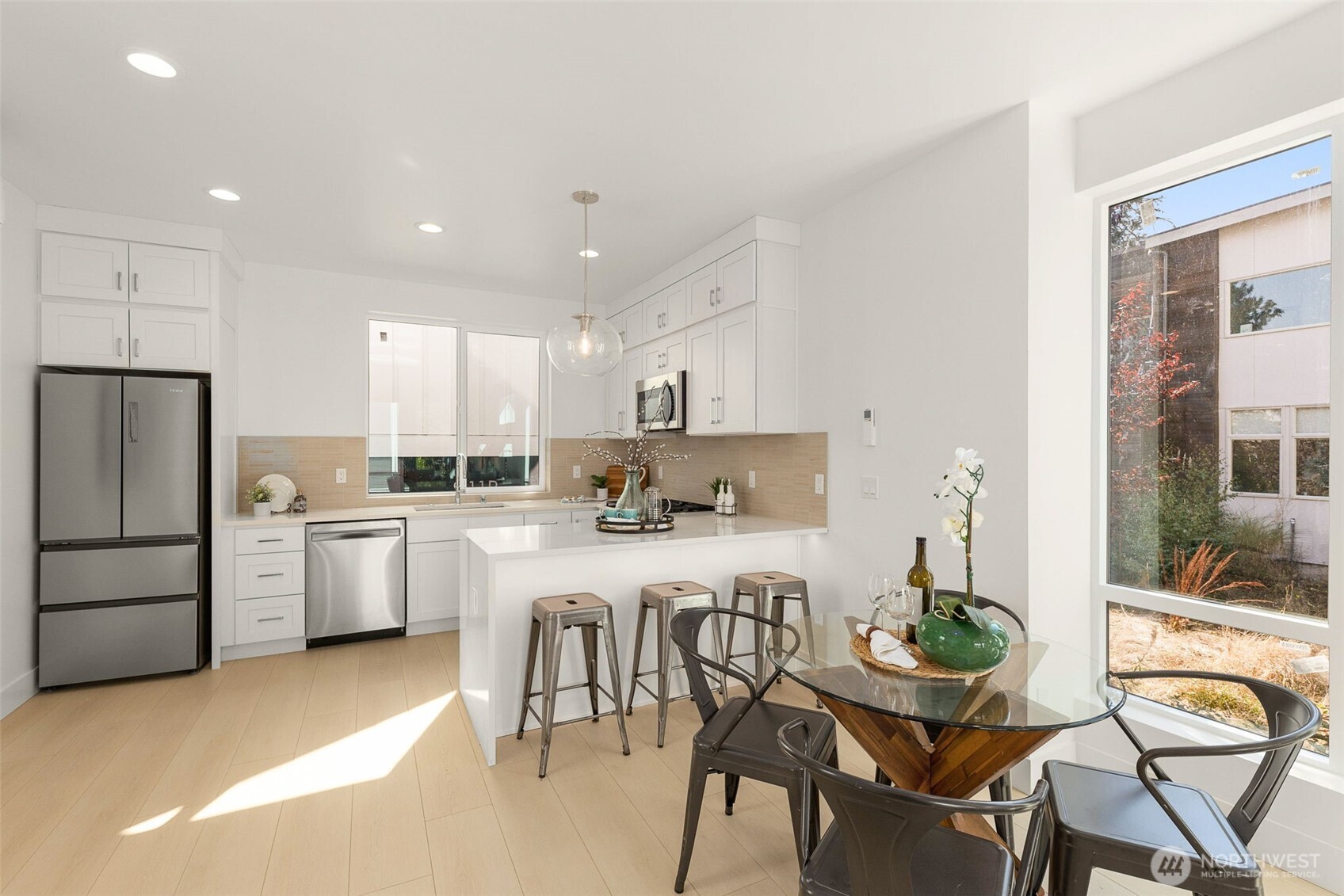911 North 98th Street, Unit A Seattle, WA 98103 - Photo 15 of 26 a kitchen with white cabinets and stainless steel appliances