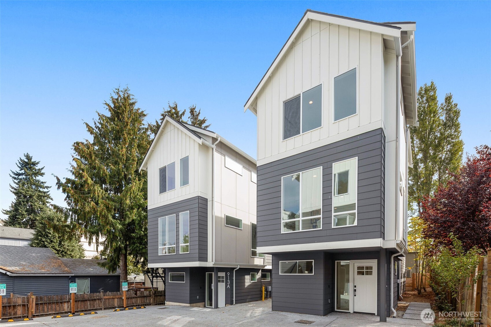 911 North 98th Street, Unit A Seattle, WA 98103 - Photo 2 of 26 a view of a white building among the street with palm trees