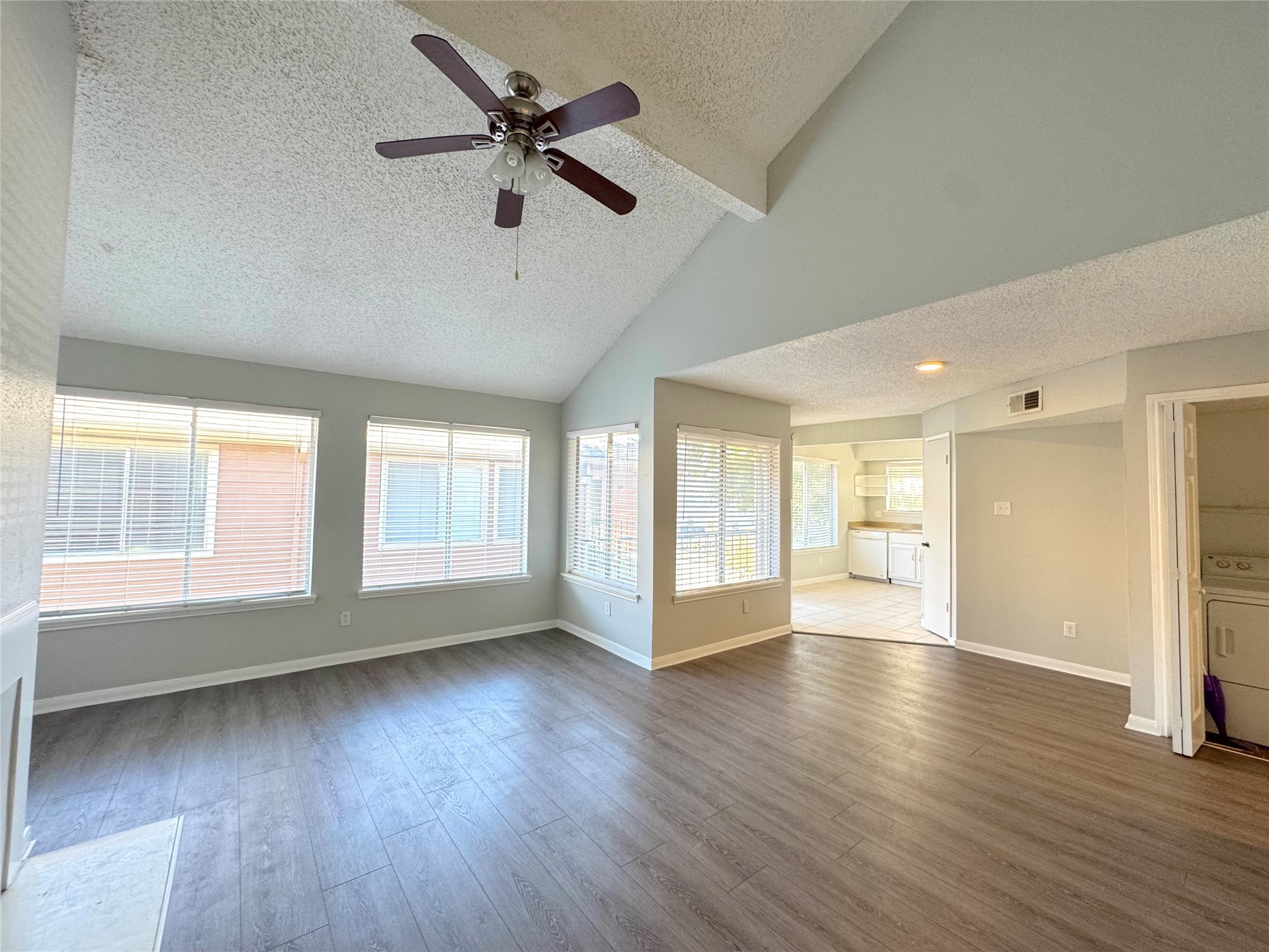 12200 Overbrook Lane, Unit 38D Houston, TX 77077 - Photo 4 of 10 a view of an empty room with a window and wooden floor