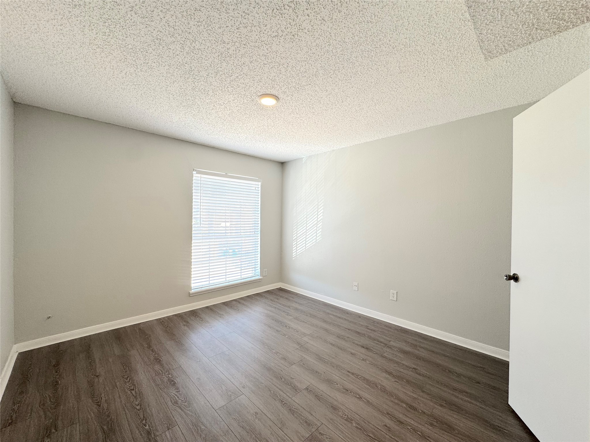 12200 Overbrook Lane, Unit 38D Houston, TX 77077 - Photo 8 of 10 a view of an empty room with wooden floor and a window