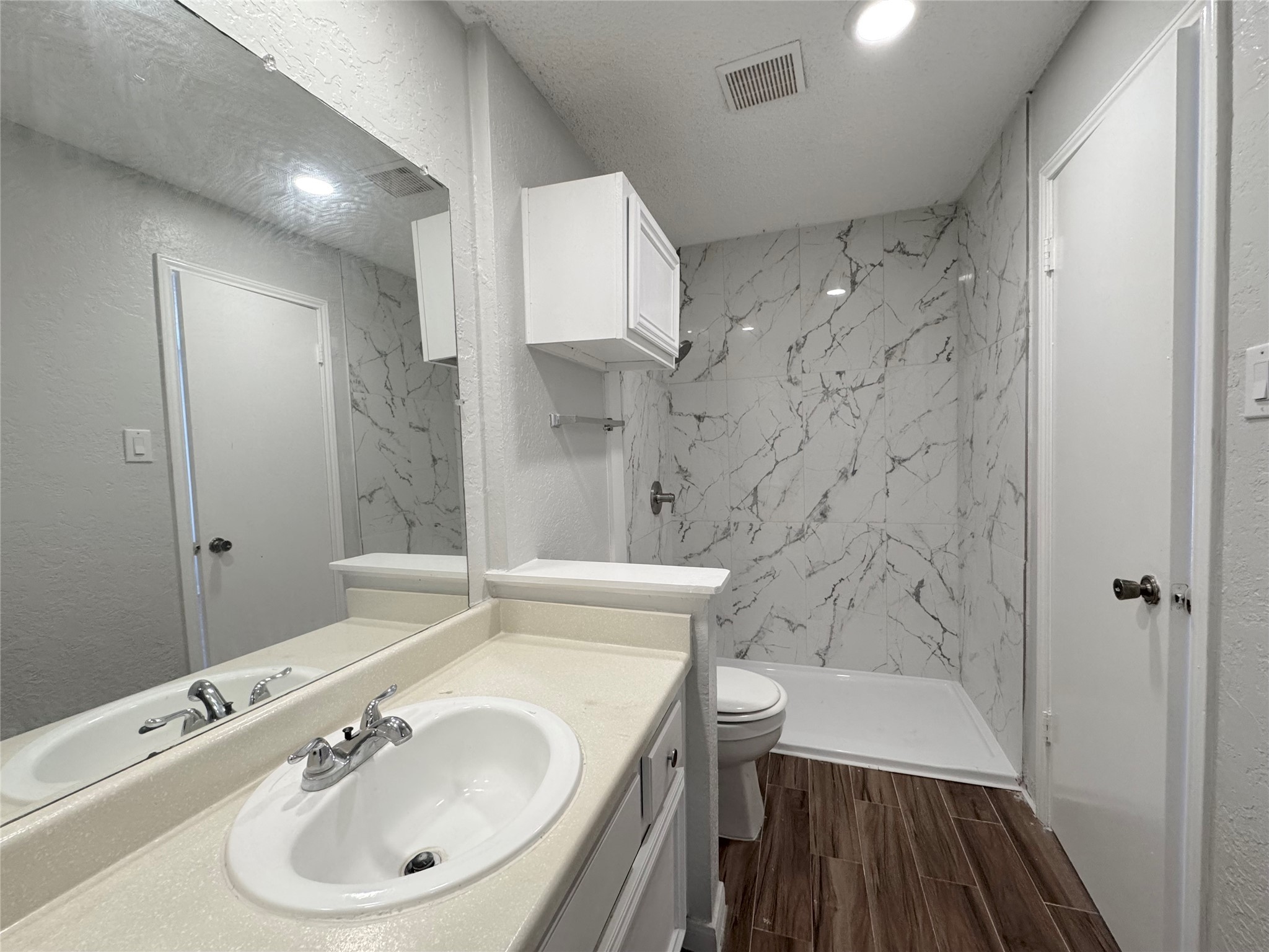 12200 Overbrook Lane, Unit 38D Houston, TX 77077 - Photo 10 of 10 a bathroom with a sink a toilet a shower and a mirror