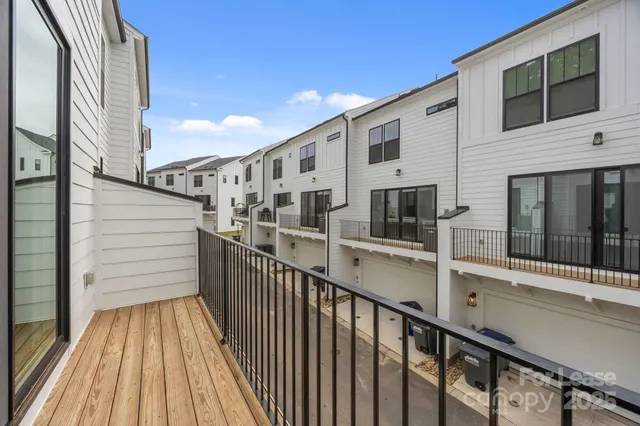 a view of a balcony with furniture and wooden floor