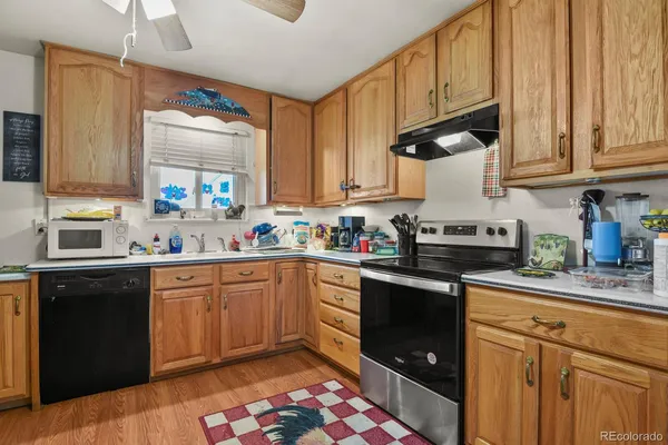 a kitchen with granite countertop a sink stainless steel appliances and cabinets