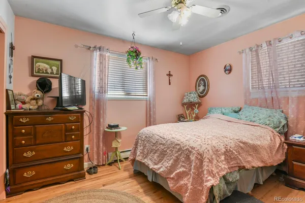 a bedroom with a bed and a dresser in it