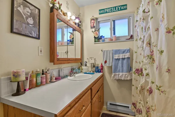 a bathroom with a sink vanity and a mirror