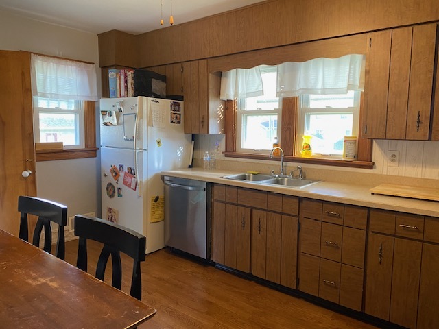 321 West 3rd Street Spring Valley, IL 61362 - Photo 4 of 14 a kitchen with a sink a refrigerator and wooden cabinets