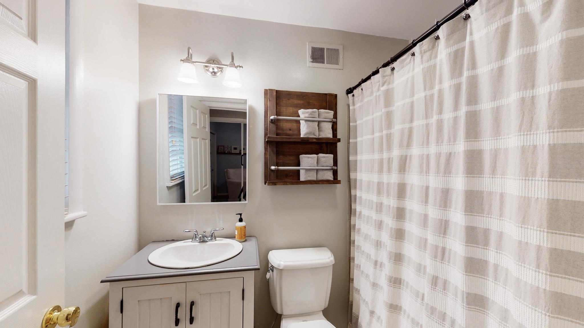 5531 Barfield Road Memphis, TN 38120 - Photo 16 of 25 a bathroom with a sink and a mirror