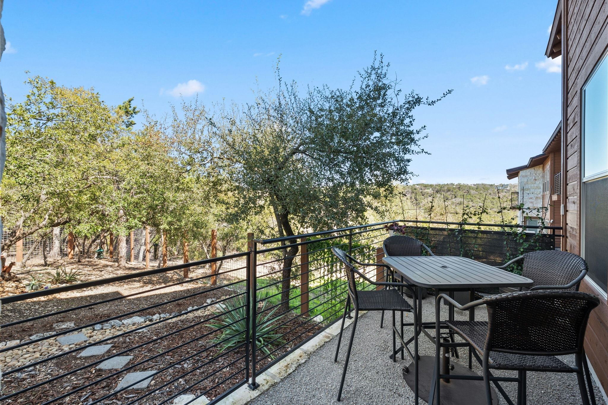 8110 Ranch Road 2222, Unit 92 Austin, TX 78730 - Photo 27 of 40 Outdoor patio with stone-finish flooring and a contemporary black metal railing