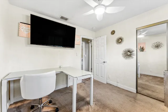 a view of a livingroom with furniture and a flat screen tv