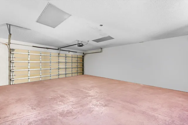 an empty room with a empty space and windows