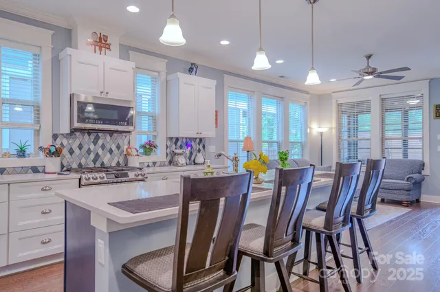 a kitchen with kitchen island granite countertop wooden cabinets and stainless steel appliances