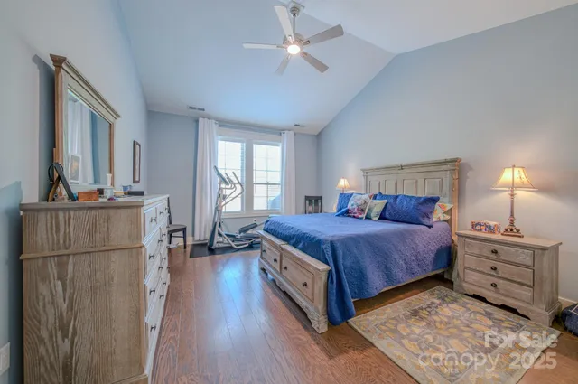 a bedroom with a bed and a refrigerator