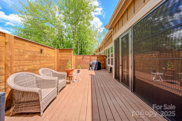 a balcony with furniture and wooden floor