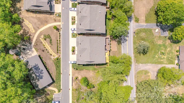 a view of a house with a yard and potted plants