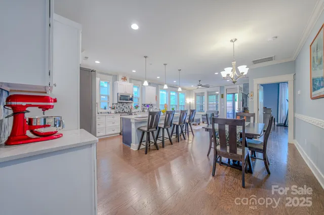 a dining area with furniture and view of kitchen