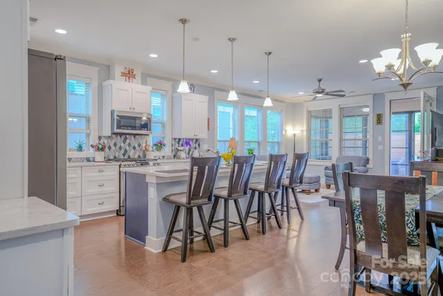 a large kitchen with a table and chairs