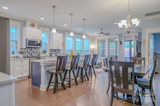 a large kitchen with a table and chairs