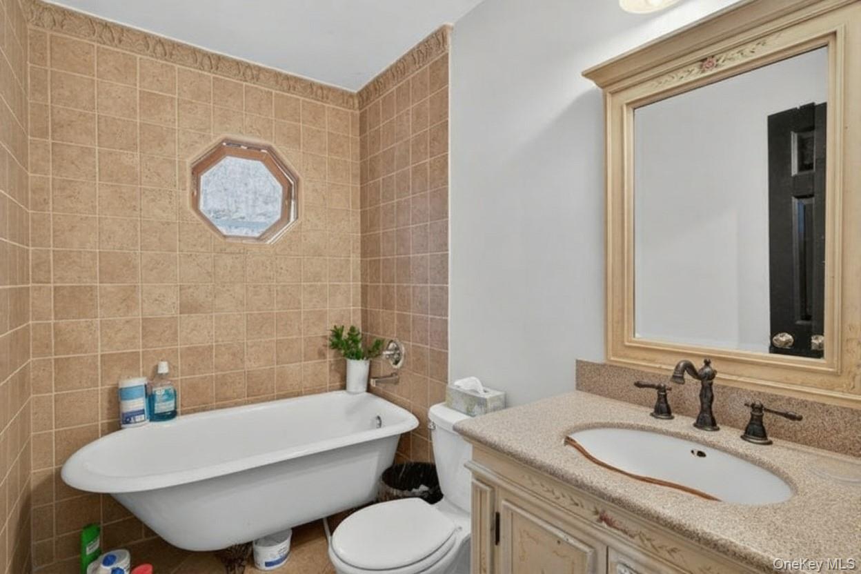 39 Peddler Hill Road Monroe, NY 10950 - Photo 14 of 30 a bathroom with a granite countertop sink mirror and toilet
