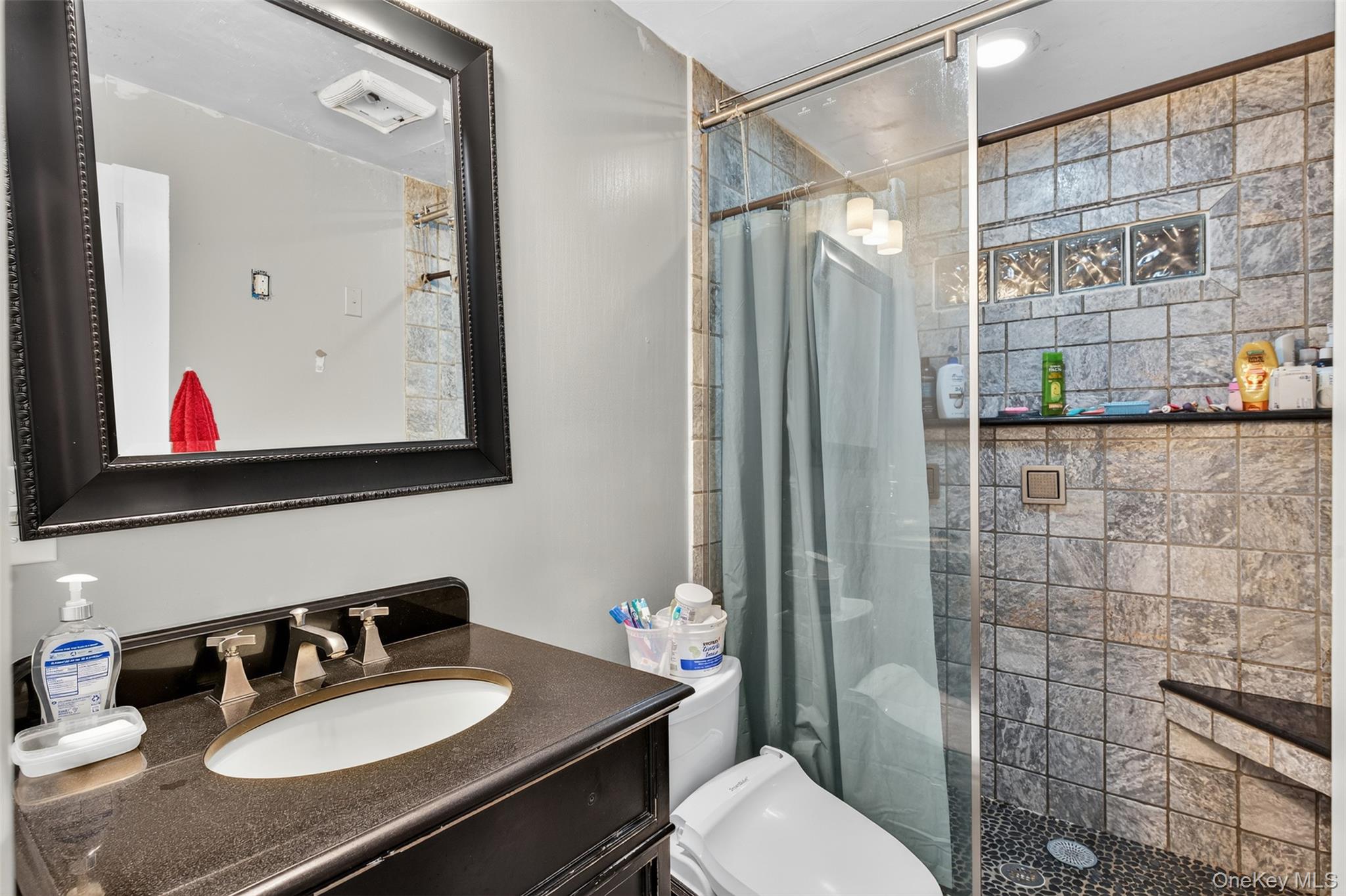 39 Peddler Hill Road Monroe, NY 10950 - Photo 18 of 30 a bathroom with a sink vanity mirror and toilet