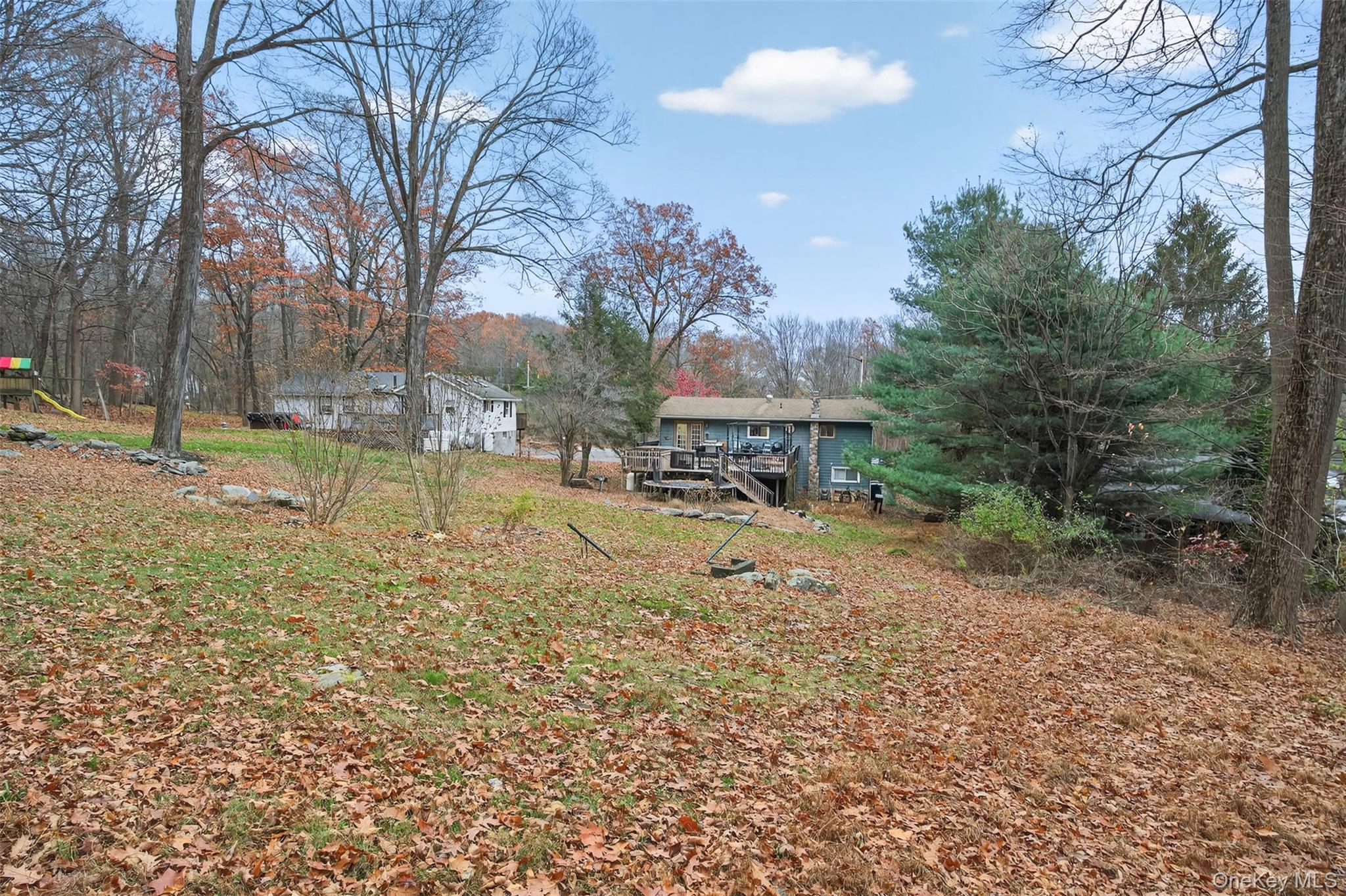 39 Peddler Hill Road Monroe, NY 10950 - Photo 24 of 30 a view of a backyard with table and chairs and a large tree