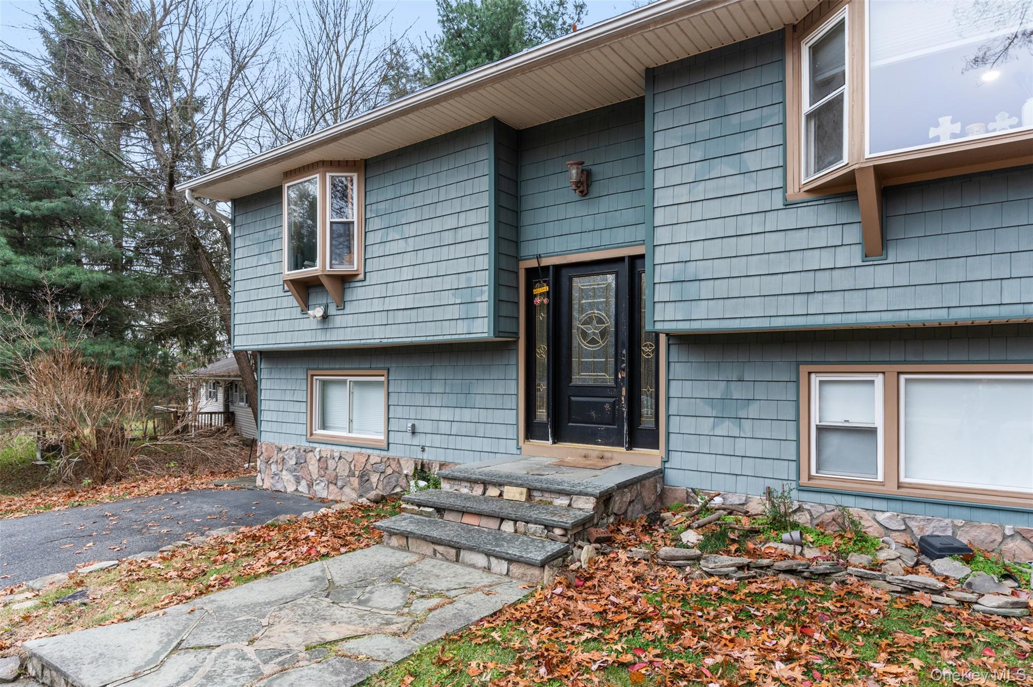 39 Peddler Hill Road Monroe, NY 10950 - Photo 4 of 30 a front view of a house with a garden