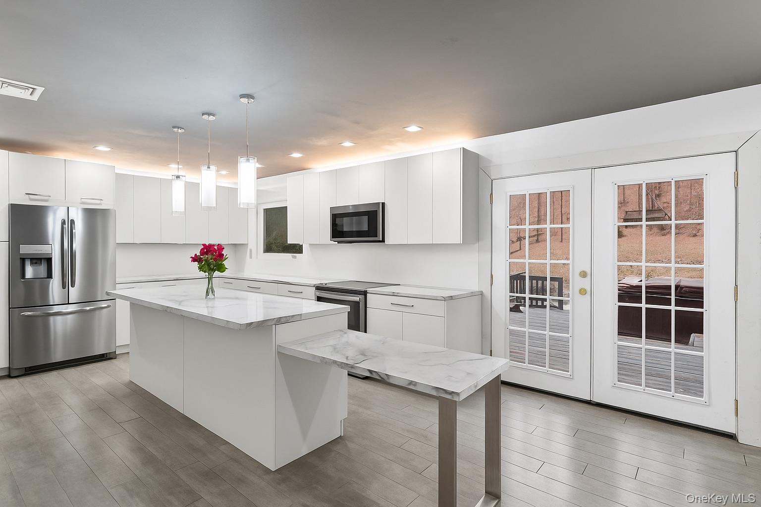 39 Peddler Hill Road Monroe, NY 10950 - Photo 9 of 30 a large white kitchen with kitchen island a sink appliances and cabinets