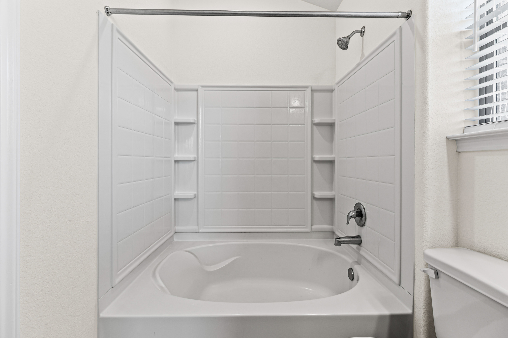17015 Gibbons Path Round Rock, TX 78664 - Photo 14 of 29 a white bath tub sitting next to a white sink and vanity