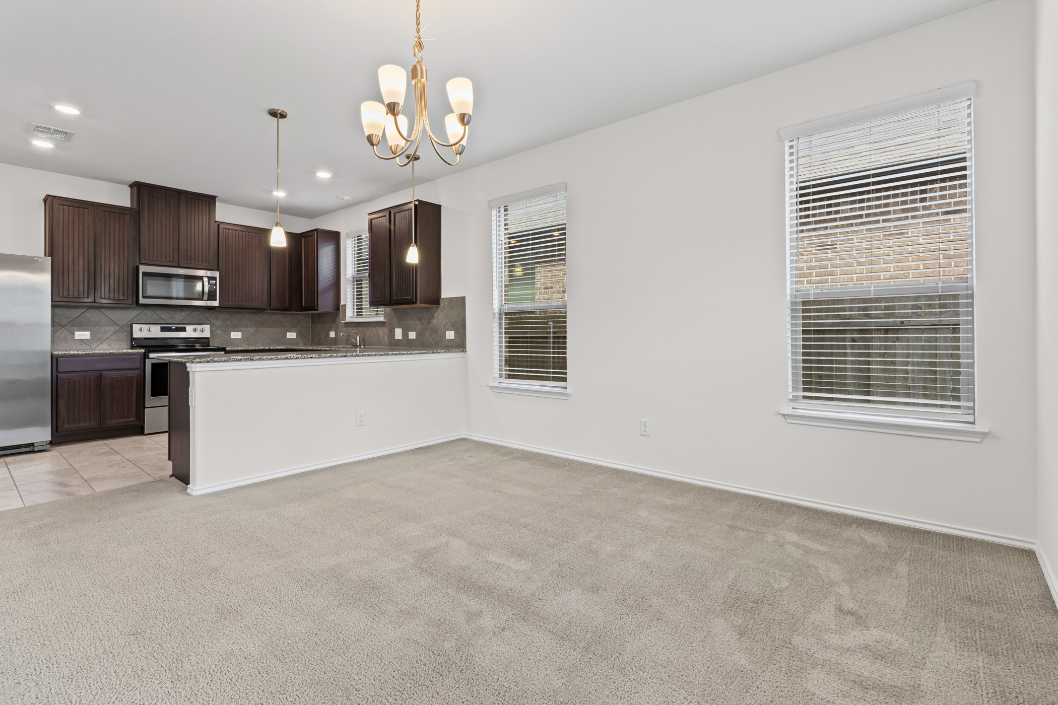 17015 Gibbons Path Round Rock, TX 78664 - Photo 7 of 29 a view of a kitchen with a sink stainless steel appliances and cabinets